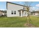 Two-story house with backyard, grassy lawn, and covered patio at 4710 Jasmine Ct, Leesburg, FL 34748