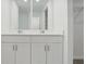 Double vanity bathroom with white cabinets and a large mirror at 4710 Jasmine Ct, Leesburg, FL 34748