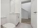 Simple bathroom with white vanity and view to upstairs at 4710 Jasmine Ct, Leesburg, FL 34748