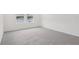 Bedroom with grey carpet and two large windows at 4710 Jasmine Ct, Leesburg, FL 34748