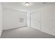 Bright bedroom with grey carpet, window, and sliding closet doors at 4710 Jasmine Ct, Leesburg, FL 34748