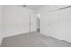 Spacious bedroom with grey carpet and double door closet at 4710 Jasmine Ct, Leesburg, FL 34748