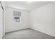 Bright bedroom with grey carpet and window views at 4710 Jasmine Ct, Leesburg, FL 34748