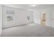 Bright bedroom with grey carpet, window, and walk-in closet at 4710 Jasmine Ct, Leesburg, FL 34748