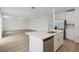 Open kitchen features a large island and stainless steel dishwasher at 4710 Jasmine Ct, Leesburg, FL 34748