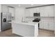 Modern kitchen with stainless steel appliances and an island at 4710 Jasmine Ct, Leesburg, FL 34748