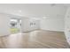 Spacious living room with light wood flooring and access to backyard at 4710 Jasmine Ct, Leesburg, FL 34748