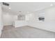 Spacious loft with grey carpet and window at 4710 Jasmine Ct, Leesburg, FL 34748