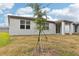 View of a new home's backyard with a young tree at 4736 Jasmine Cir, Leesburg, FL 34748