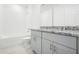 Bathroom with granite countertop double vanity and a shower/tub combo at 4736 Jasmine Cir, Leesburg, FL 34748