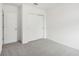 Simple bedroom with grey carpet and double door closet at 4736 Jasmine Cir, Leesburg, FL 34748