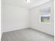 Spacious bedroom with grey carpet and large window at 4736 Jasmine Cir, Leesburg, FL 34748