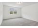 Spacious bedroom with grey carpet and a large window at 4736 Jasmine Cir, Leesburg, FL 34748