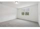 Bright bedroom featuring grey carpet and natural light at 4736 Jasmine Cir, Leesburg, FL 34748