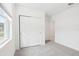 Bright bedroom featuring grey carpet and a double door closet at 4736 Jasmine Cir, Leesburg, FL 34748