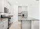Modern kitchen with gray cabinets, granite countertops, and stainless steel appliances at 4736 Jasmine Cir, Leesburg, FL 34748