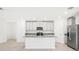 Modern kitchen with gray cabinets, granite countertops and island at 4736 Jasmine Cir, Leesburg, FL 34748