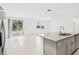 Open concept kitchen and living area with tile floors and sliding glass doors at 4736 Jasmine Cir, Leesburg, FL 34748