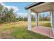 Covered patio with pavers overlooking a backyard and pond at 4736 Jasmine Cir, Leesburg, FL 34748