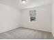 Spacious bedroom with grey carpet and a window at 4751 Jasmine Cir, Leesburg, FL 34748