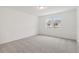 Spacious bedroom with gray carpet and a window at 4751 Jasmine Cir, Leesburg, FL 34748