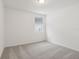 Well-lit bedroom with grey carpet and window at 4751 Jasmine Cir, Leesburg, FL 34748