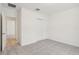 Simple bedroom with grey carpet and double door closet at 4751 Jasmine Cir, Leesburg, FL 34748