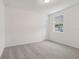 Bright bedroom with grey carpet and a window at 4751 Jasmine Cir, Leesburg, FL 34748
