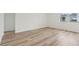 Empty bedroom with light wood-look flooring and large window at 4751 Jasmine Cir, Leesburg, FL 34748