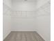 Large closet with wire shelving and gray carpet at 4751 Jasmine Cir, Leesburg, FL 34748