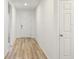 Light and bright entryway with wood-look flooring and white walls at 4751 Jasmine Cir, Leesburg, FL 34748
