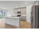 Open kitchen featuring a large island and stainless steel appliances at 4751 Jasmine Cir, Leesburg, FL 34748