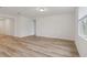 Spacious living room featuring light wood-look floors and bright white walls at 4751 Jasmine Cir, Leesburg, FL 34748