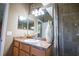 Clean bathroom with wood vanity and walk-in shower at 1400 Arlington St, Orlando, FL 32805