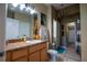 Main bathroom with wood cabinets and a large mirror at 1400 Arlington St, Orlando, FL 32805