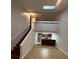 Open kitchen with dark wood cabinets and a loft area above at 174 Waterfall Way # 106, Altamonte Springs, FL 32714