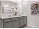 Double vanity bathroom with gray cabinets and a shower at 3827 Rory Pond Ct, Lakeland, FL 33811