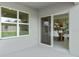 Covered back patio with sliding glass doors leading to dining area and a view of the backyard at 3827 Rory Pond Ct, Lakeland, FL 33811