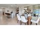 Open concept kitchen and dining area with modern appliances and breakfast bar at 3827 Rory Pond Ct, Lakeland, FL 33811