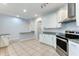 Modern kitchen with white cabinets and granite island at 3984 Beacon Ridge Way, Clermont, FL 34711