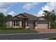 Two-story home with neutral siding and a three-car garage at 5379 Park Guell St, St Cloud, FL 34771