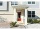 Inviting front entrance with a red door and stone accents at 7916 Waterfield Ave, Orlando, FL 32832