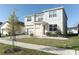 Two-story house with gray siding, red door, and a landscaped yard at 7916 Waterfield Ave, Orlando, FL 32832