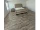 Main bedroom with plush upholstered bed and wood-look flooring at 7916 Waterfield Ave, Orlando, FL 32832