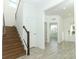 Bright and airy entryway with wood stairs and tile flooring at 7916 Waterfield Ave, Orlando, FL 32832