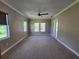 Primary bedroom with plush carpeting and access to the backyard at 0 Iron Bridge Rd, Oviedo, FL 32765