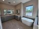 Luxurious Primary bathroom with soaking tub and double vanity at 0 Iron Bridge Rd, Oviedo, FL 32765