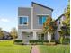 Modern two-story home with gray exterior, landscaped yard, and a paved walkway at 14773 Crimson Bluff Aly, Winter Garden, FL 34787