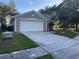 House exterior with a two-car garage and walkway at 2416 Sapier Ct, Orlando, FL 32837