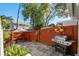 Outdoor grilling area with patio, wooden fence, and landscaping at 4522 Brook Hollow Cir, Winter Springs, FL 32708